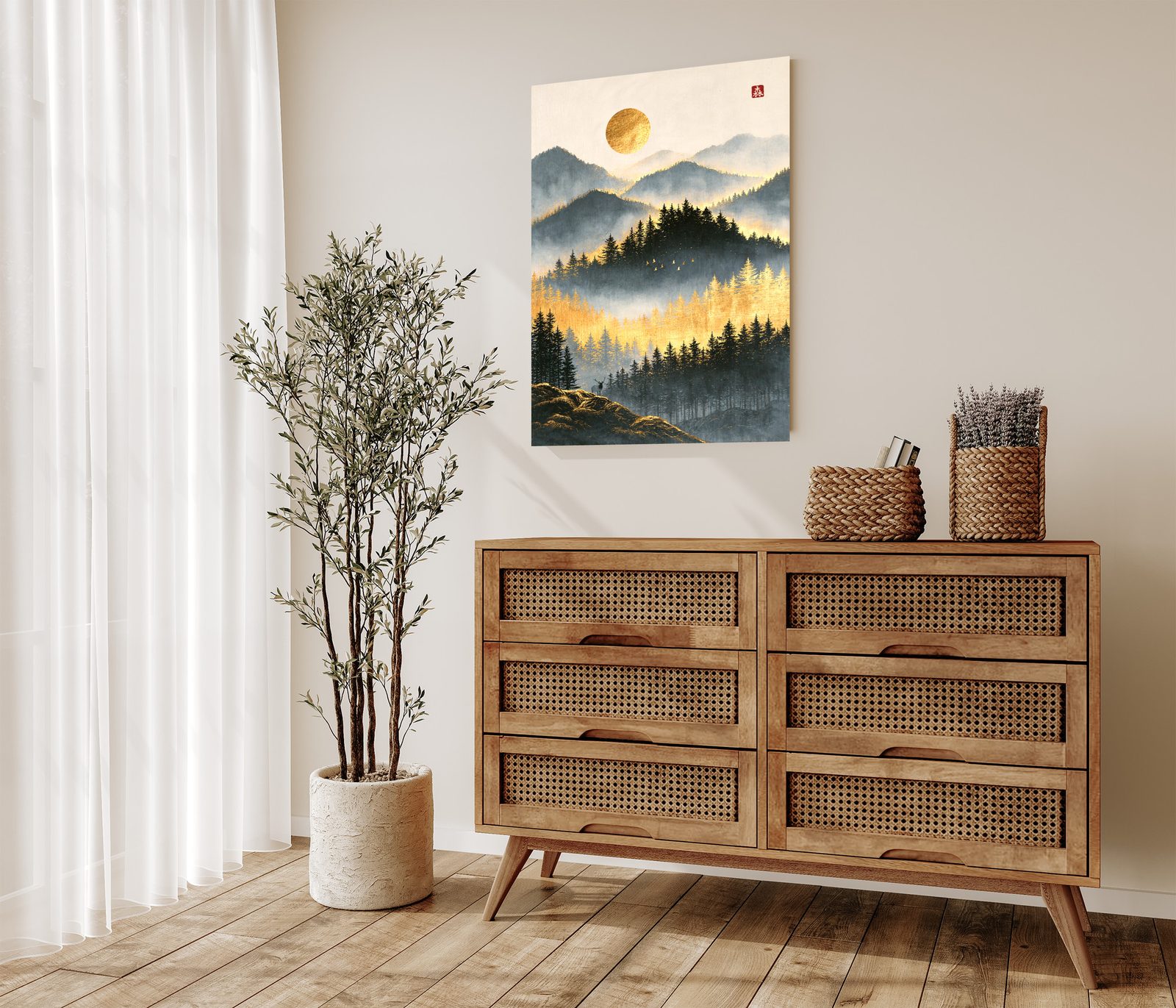 Where the Forest Turns to Gold: a band of golden larches glows between dark pines in the mist, with ridges fading toward a round gold sun. Birds cross the valley, and a small stag stands on a hill in the foreground. A red seal sits in the upper right. The print hangs above a wooden chest of drawers with rattan fronts. Woven baskets stand on top. Long white curtains and an olive tree in a pale pot are on the left.